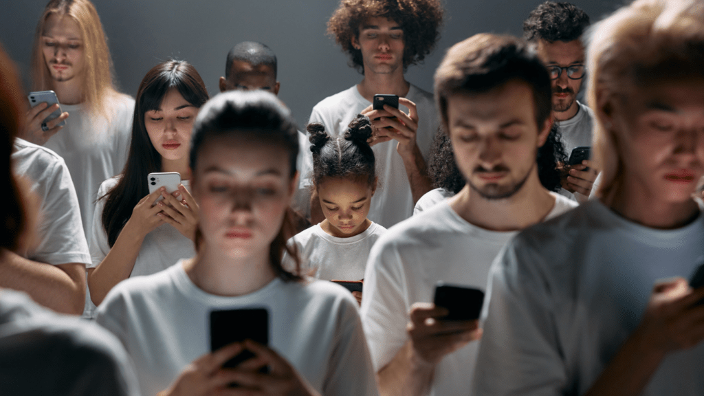 a group of people in white shirts looking at their phones