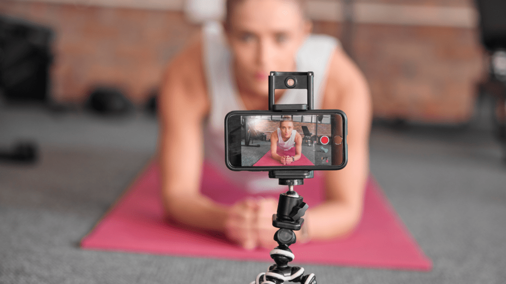 A person is holding up a phone while sitting in front of a mirror