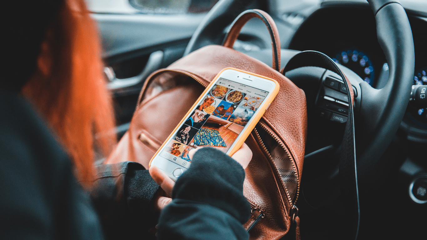 a person using their phone while driving a car