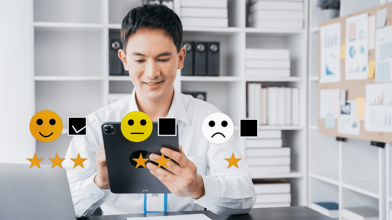 A person is looking at a tablet with five smiley faces on it