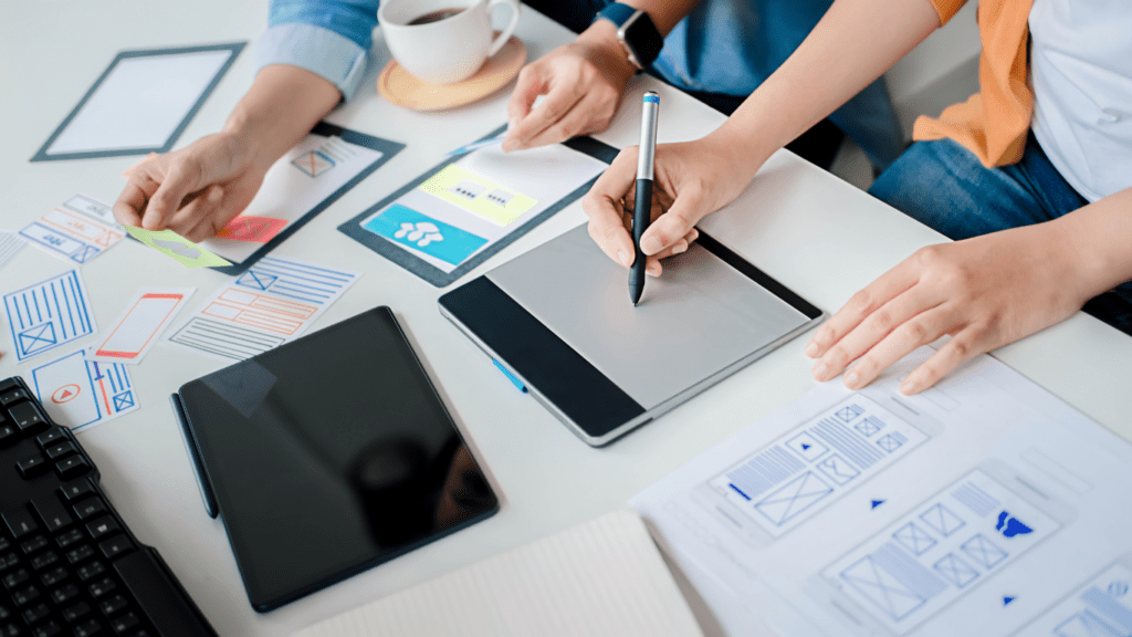 a group of people working on a project at a desk