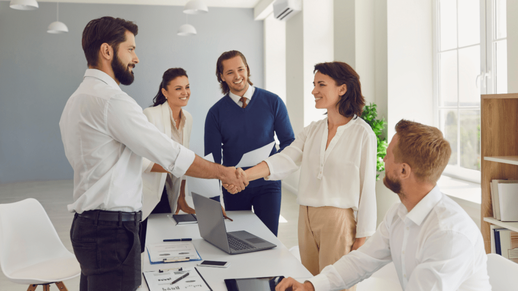 a group of business people shaking hands in an office