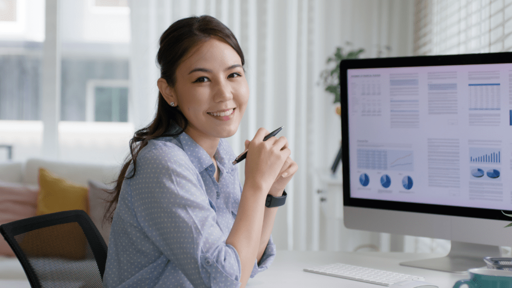 a person sitting at a desk in front of a computer screen