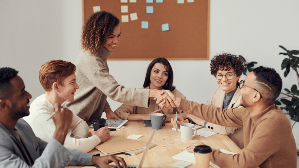 a group of business people shaking hands in an office