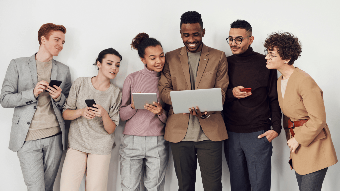 a group of people in white shirts looking at their phones