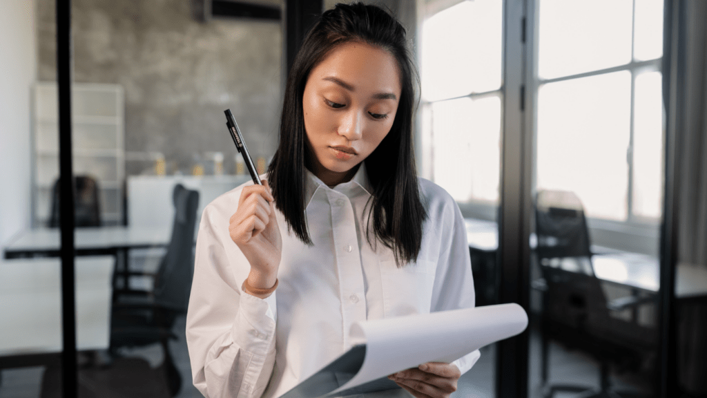 a person in a business suit holding a clipboard