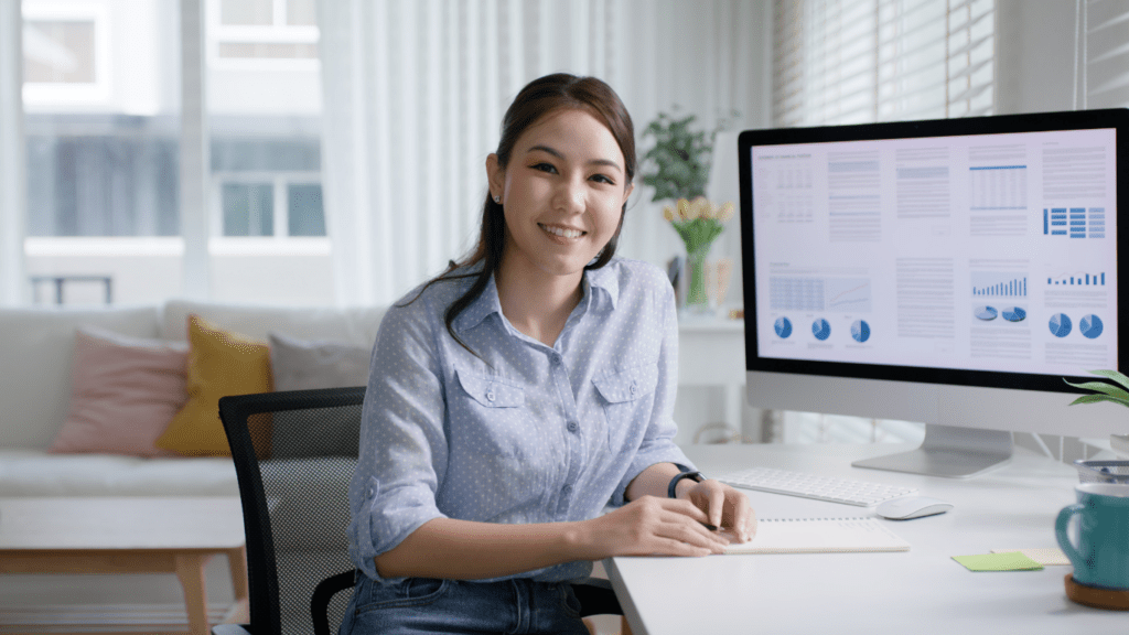 a person sitting at a desk in front of a computer screen