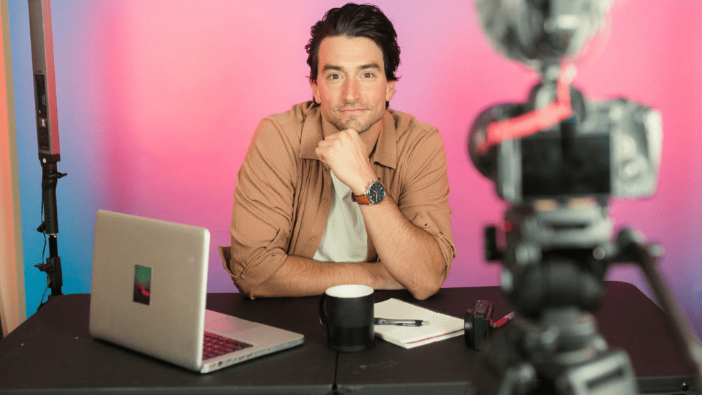 a person sitting in a living room with a camera in front of them