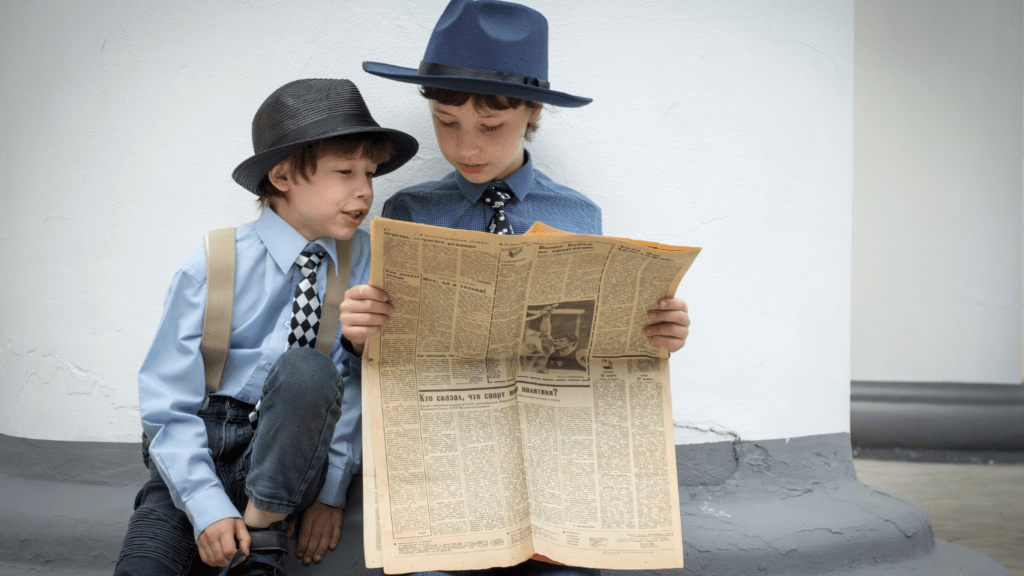 two people looking at a newspaper