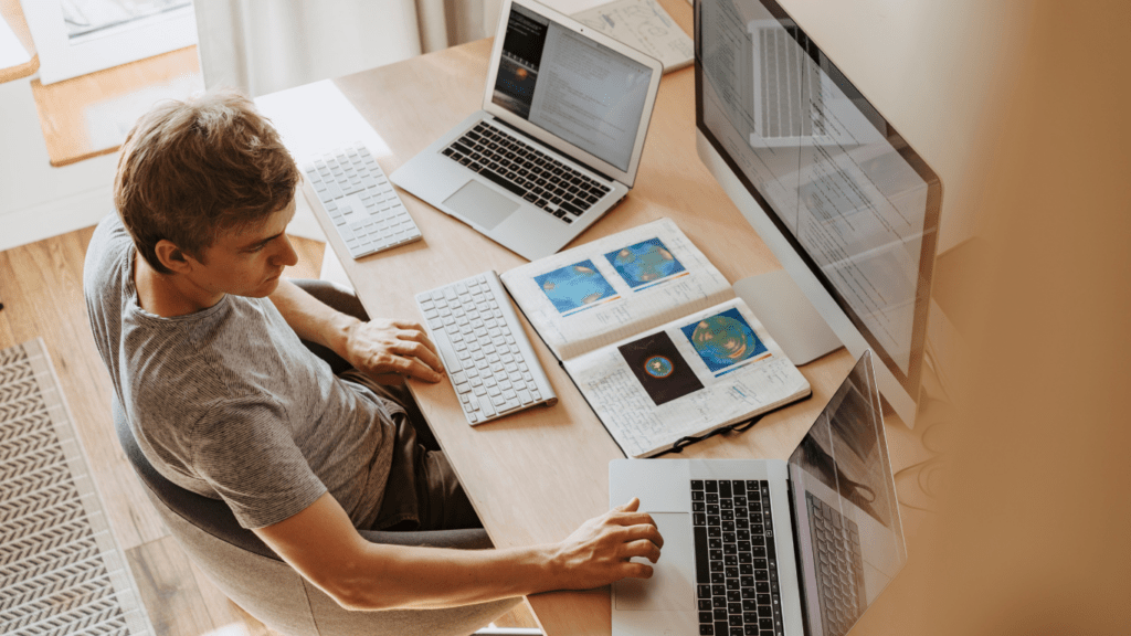 two people working on their laptops in front of each other